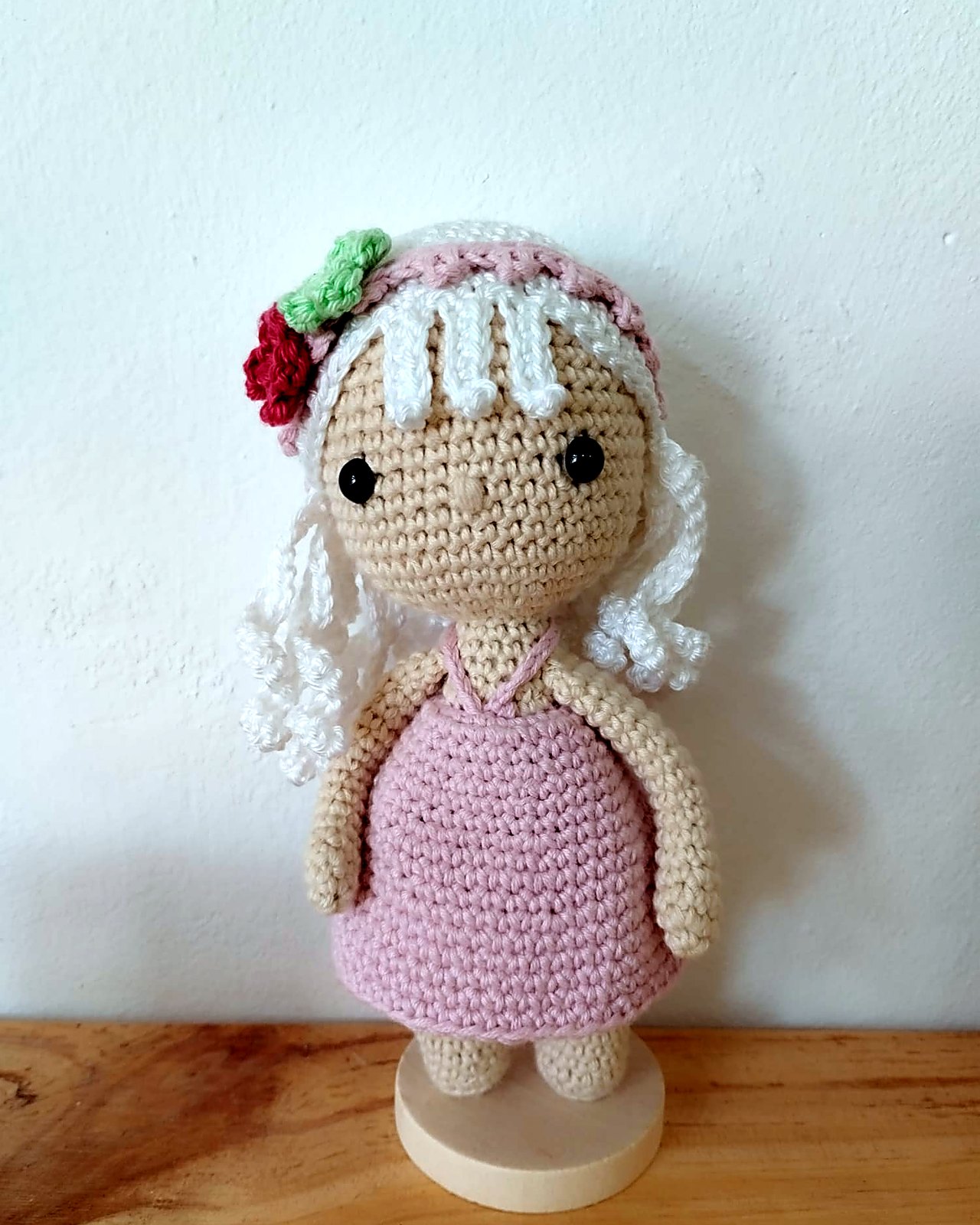 Muneca amigurumi rubia con corona de flores y vestido rosa