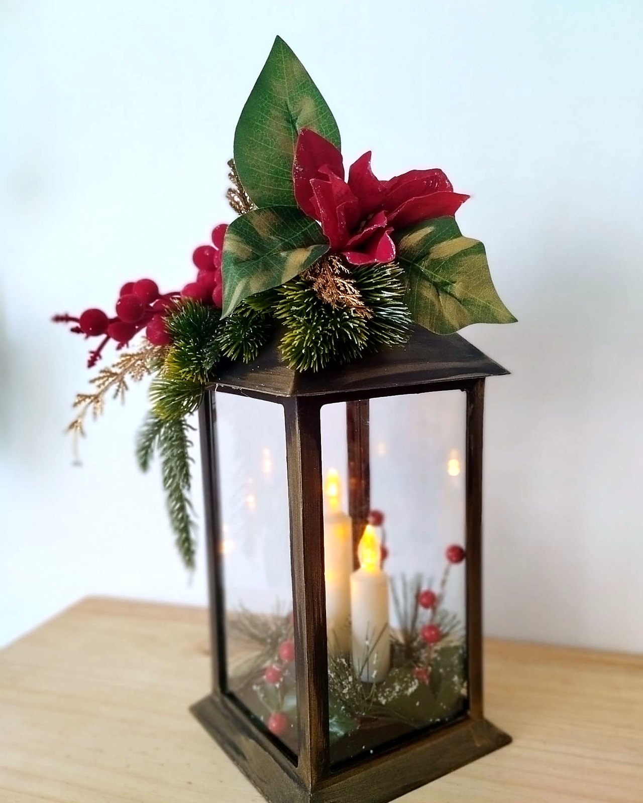 Farol metalico con tres velas y flor de pascua